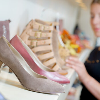 Shoes on shelf, unfocused lady in background